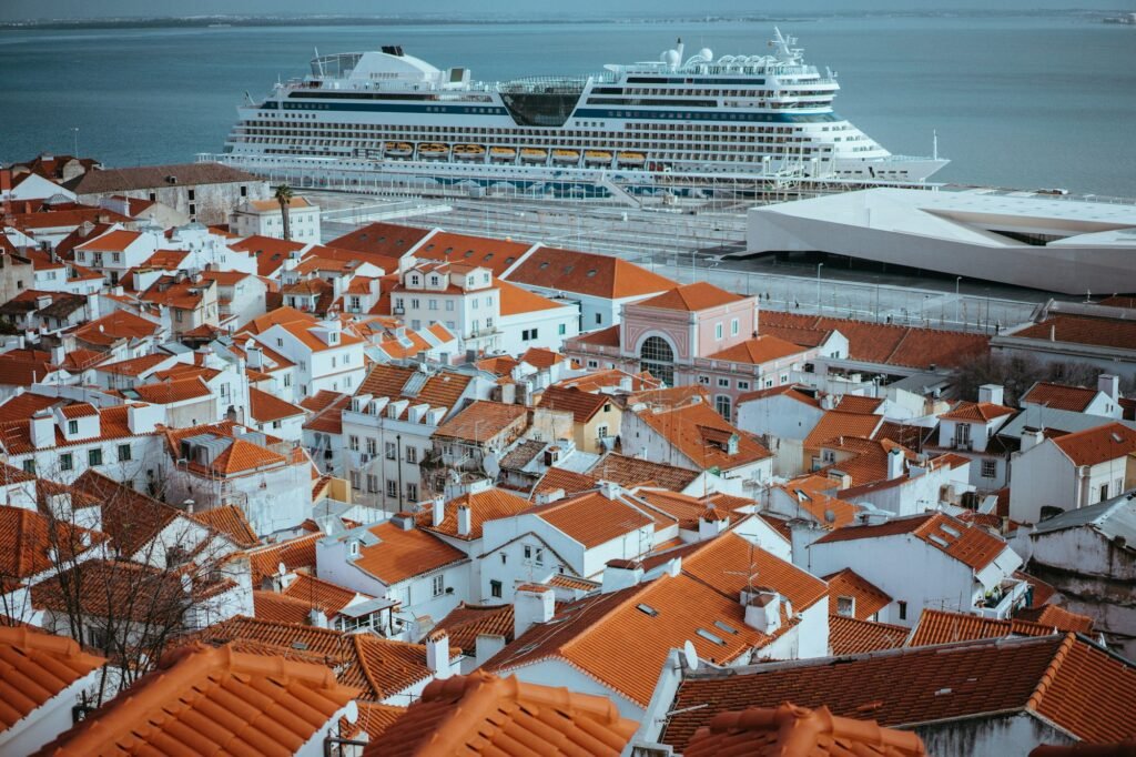 Rooftopspanorama of the oldest district Alfama in Lisbon. Cruise boat on the Tagus River. Lisbon